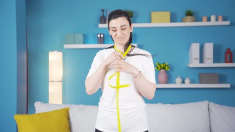 Unhappy-person-measuring-her-weight-with-a-tape-measure.